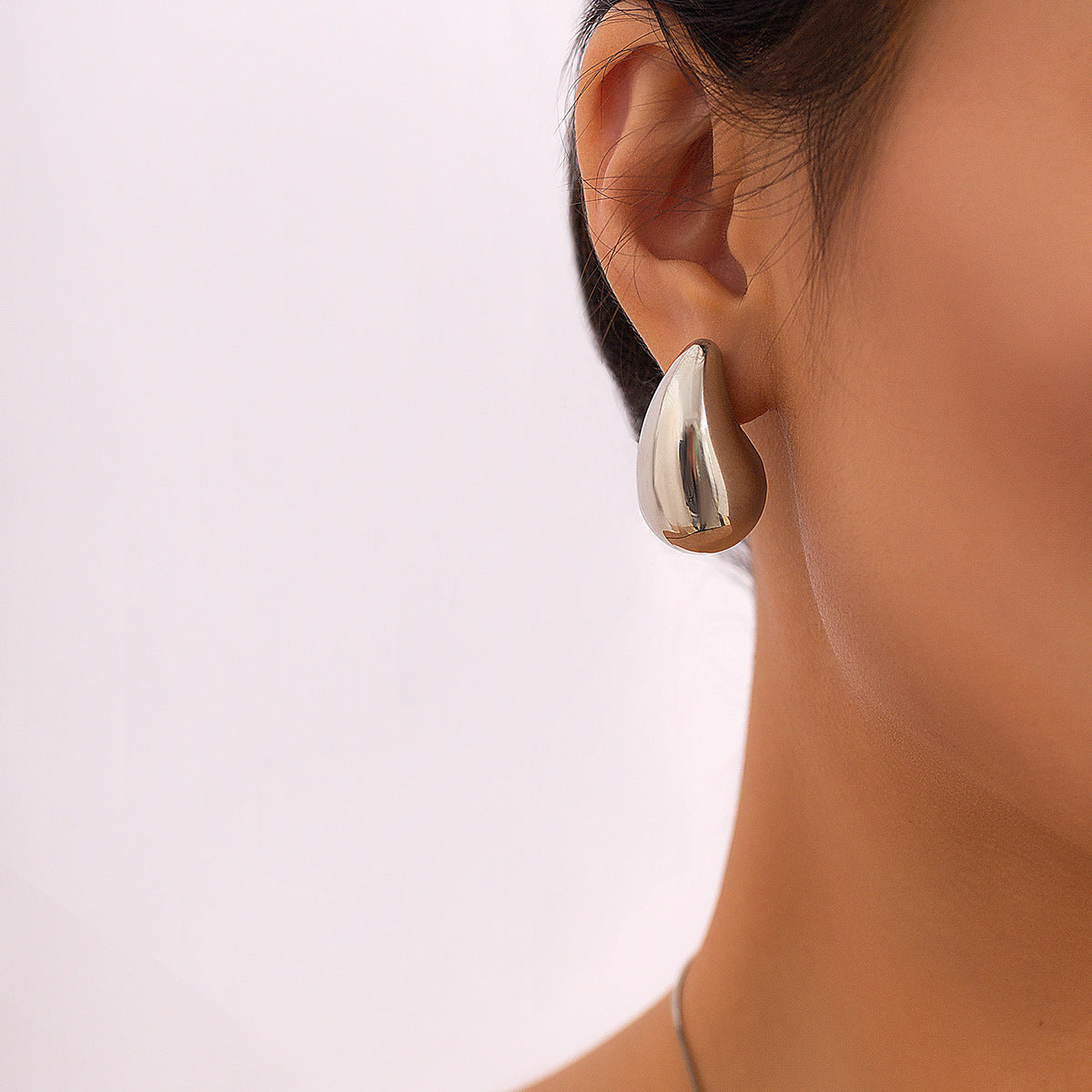 Minimally designed droplet hanging party punk ring with smooth and exaggerated surface, large size with tears, niche necklace